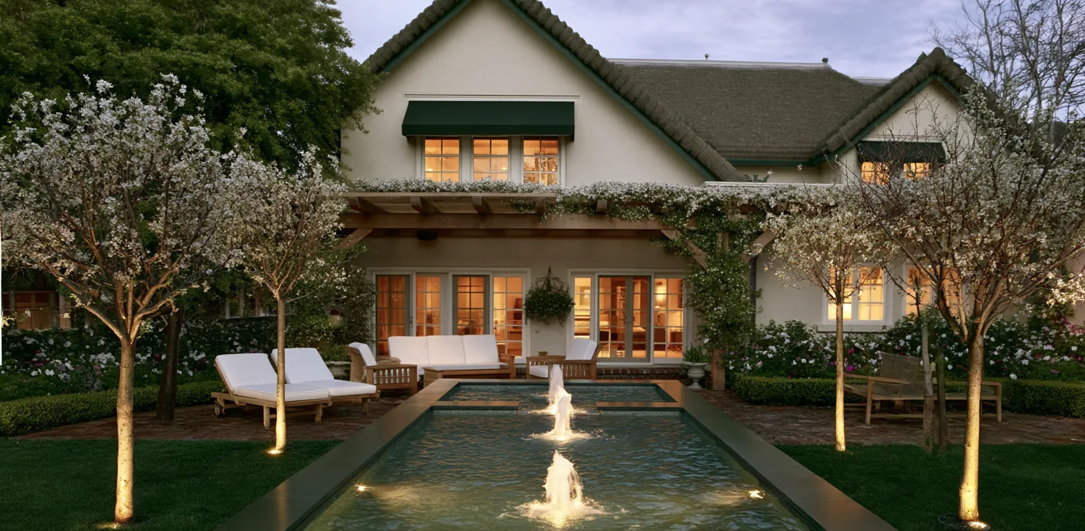 Riverside formal garden with reflecting pool and perennial borders